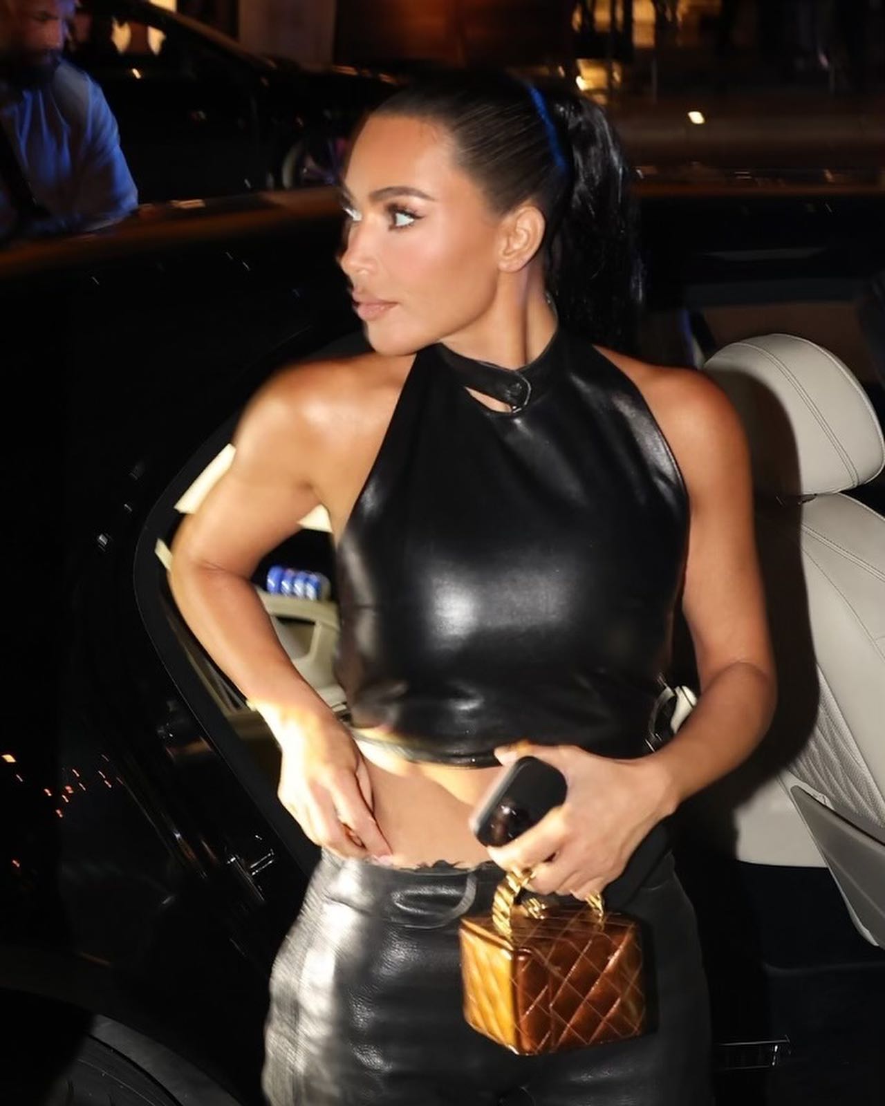 Kim Kardashian flashes her famous butt in skintight black leather pants while partying in Miami for sexy pics