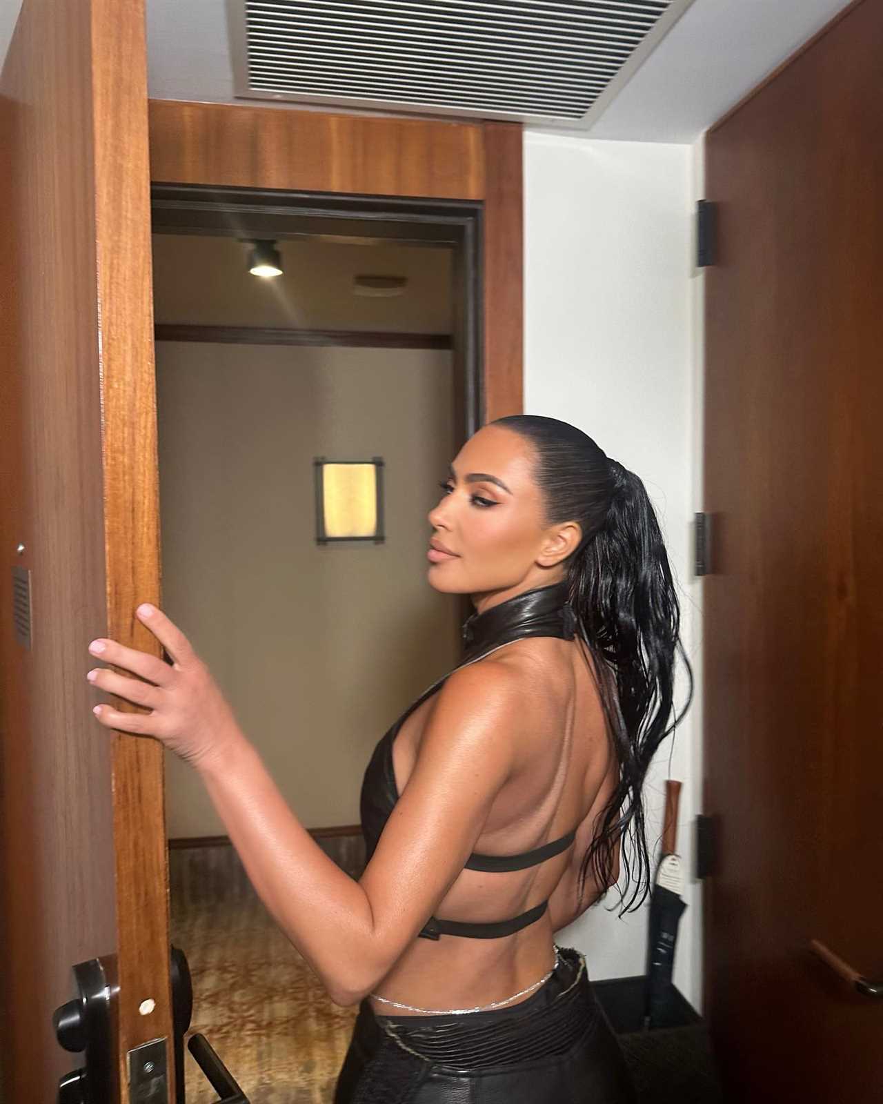 Kim Kardashian flashes her famous butt in skintight black leather pants while partying in Miami for sexy pics