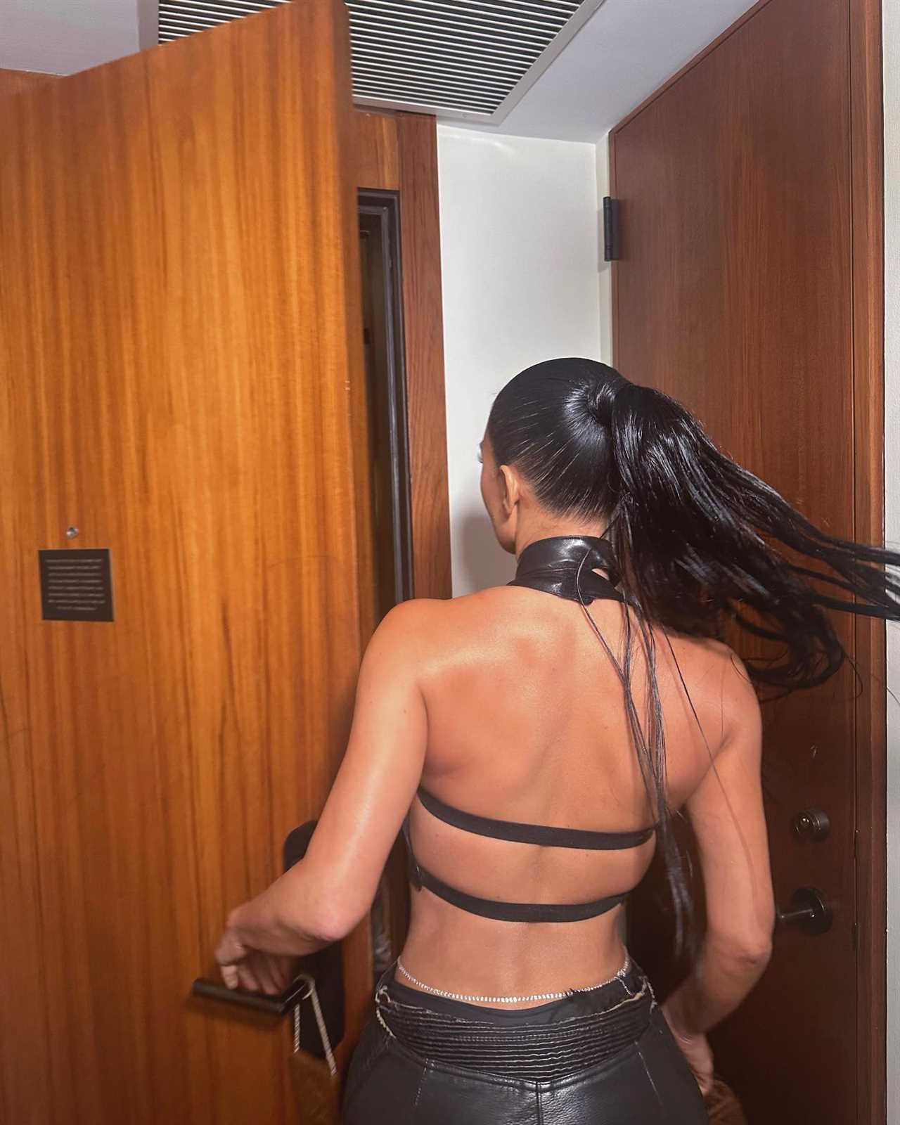 Kim Kardashian flashes her famous butt in skintight black leather pants while partying in Miami for sexy pics