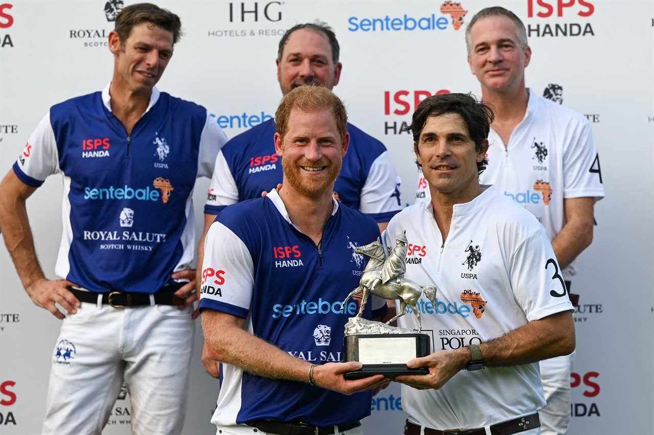 Britain's Prince Harry (front L) and Argentine polo player Nacho Figueras (front R) receive a shared trophy after the Sentebale ISPS Handa Polo Cup in Singapore on August 12, 2023. (Photo by Roslan RAHMAN / AFP) (Photo by ROSLAN RAHMAN/AFP via Getty Images)