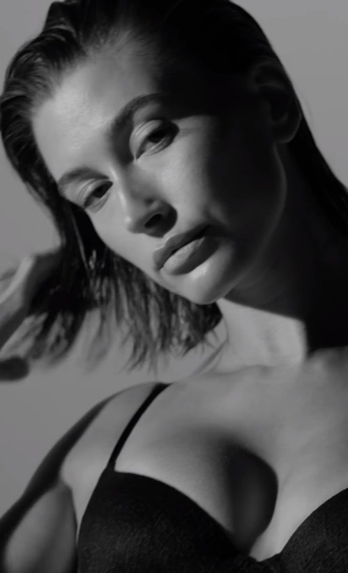 Hailey Bieber shows off her bare stomach in tiny black lingerie for new video as fans suspect star is pregnant