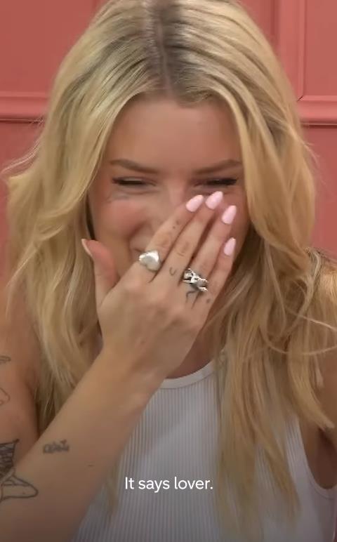 Awkward moment Lottie Moss is left red-faced after co-star misreads her face tattoo