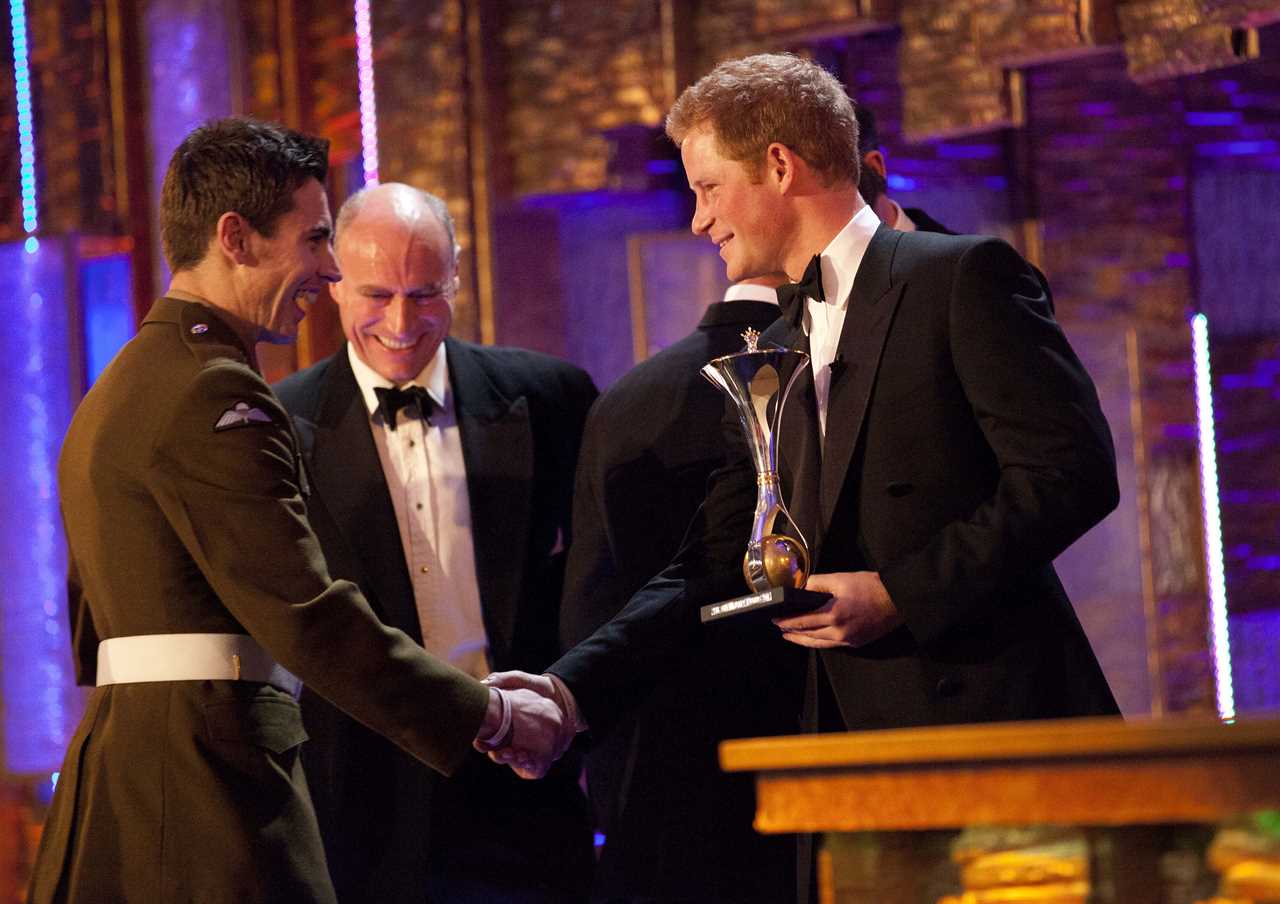 The Celeb Report Military Awards  ( Millies ) at The Imperial War Museum  December 19, 2011 in London. Prince Harry presents the  Support to the armed forces award to Walking with the wounded, to Private Jaco Van Gass 19.12.2011 PICTURE BY LEE THOMPSON