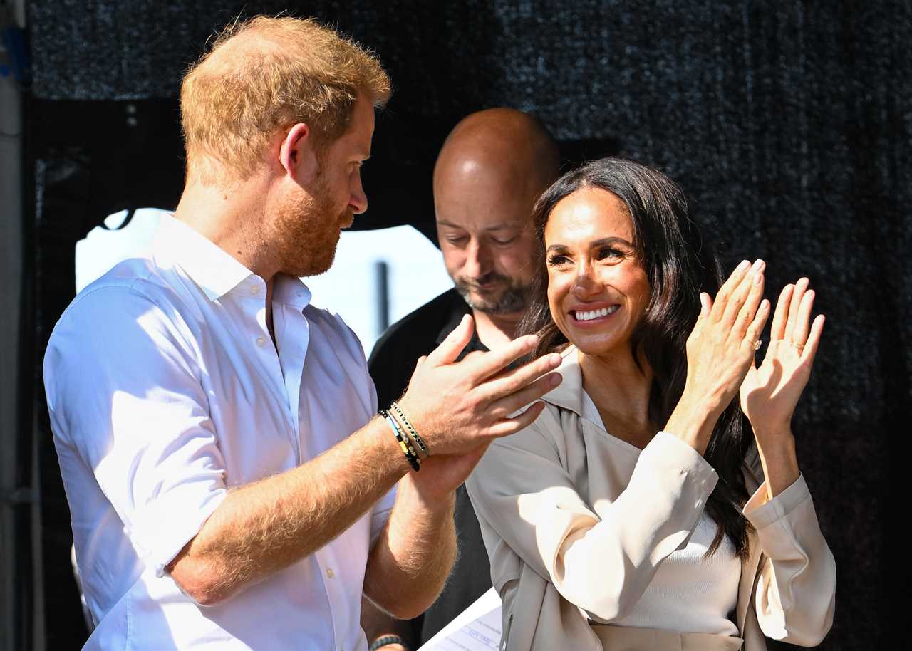 Meghan Markle and Prince Harry hold hands as they appear for last day of Invictus Games