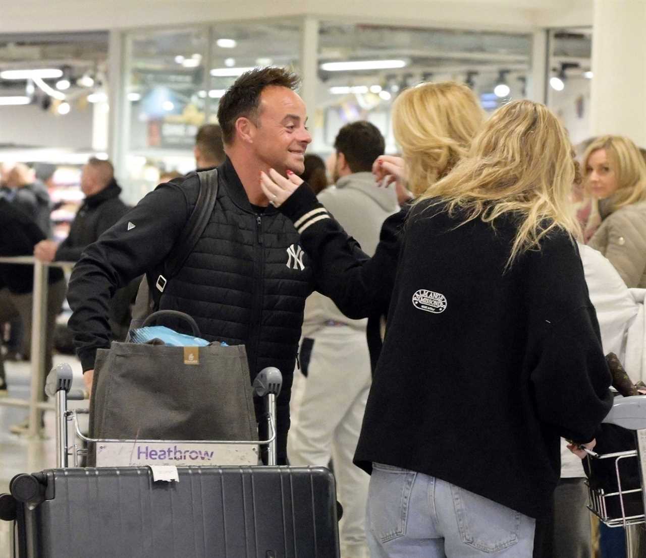 Ant McPartlin shares a passionate kiss with wife Anne-Marie as they reunite at Heathrow Airport