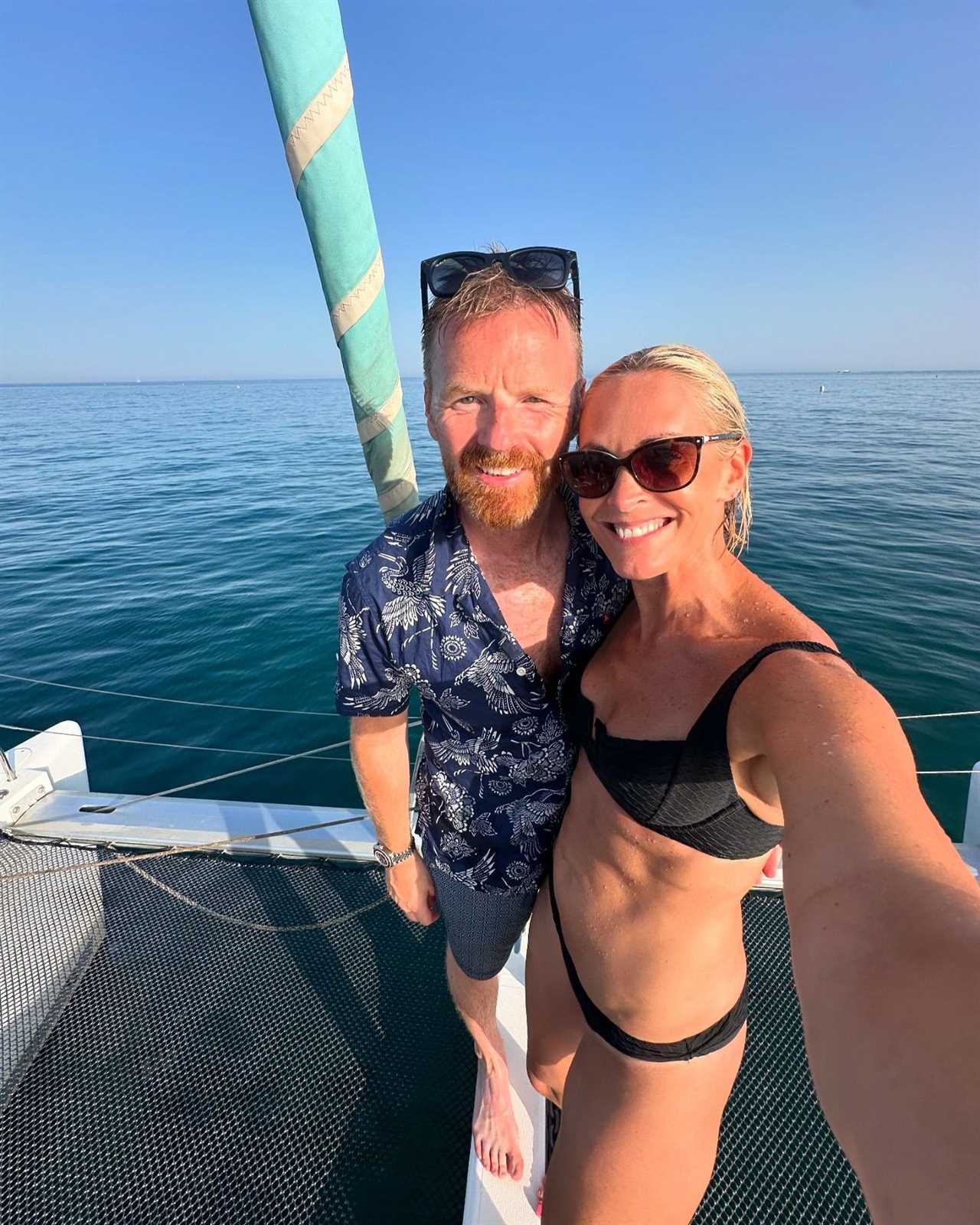 Jenni Falconer wows in barely-there bikini as she dives off a yacht in Spain