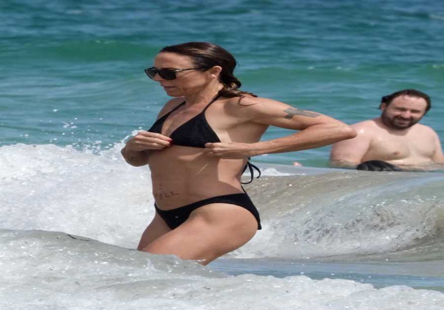 Mel C flaunts washboard abs in black bikini as she hits the beach in Ibiza