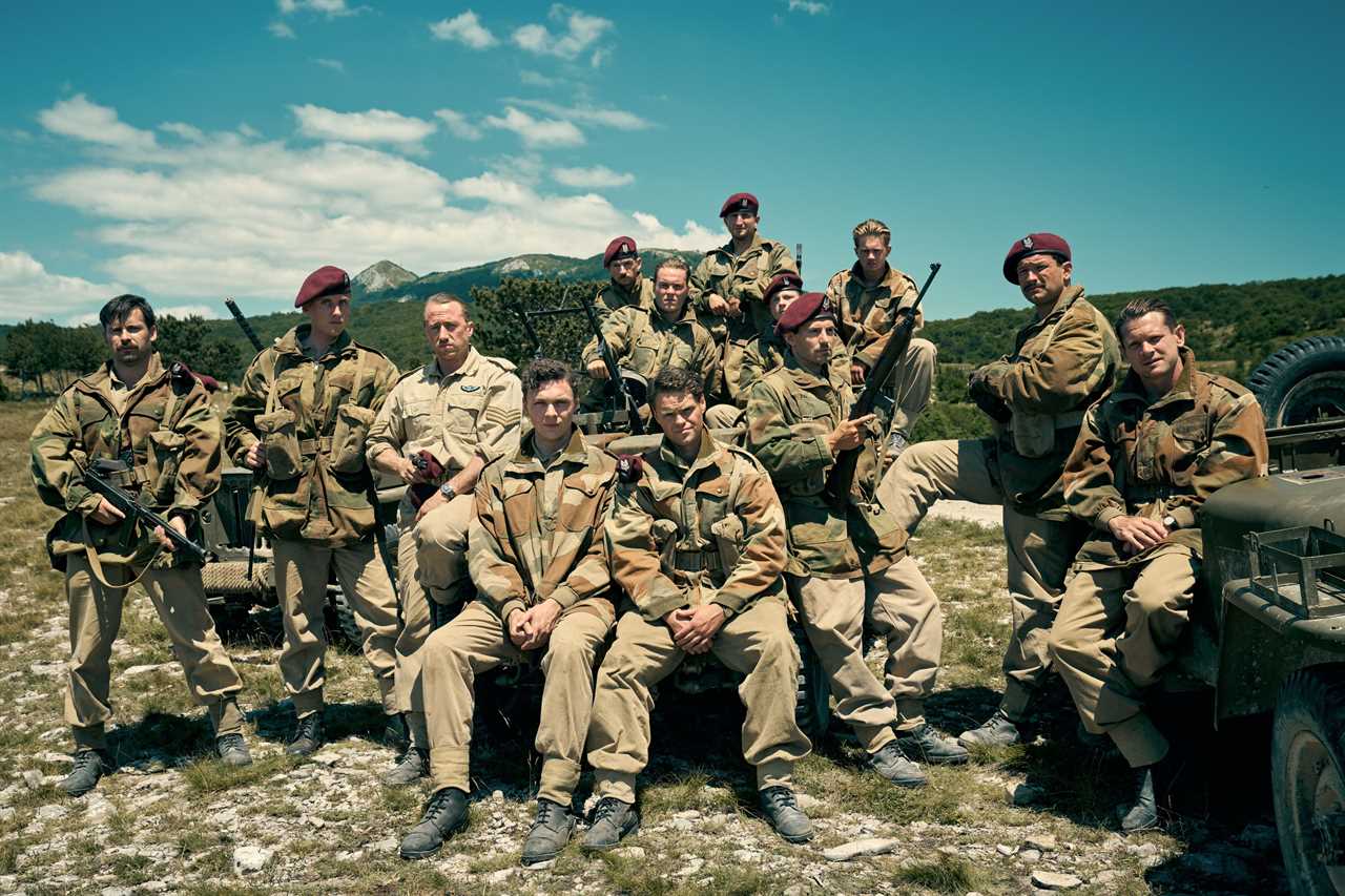 a group of men in military uniforms pose for a picture