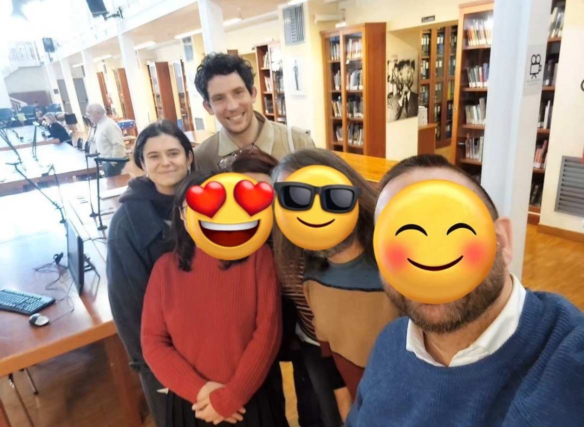 a group of people posing for a picture in a library