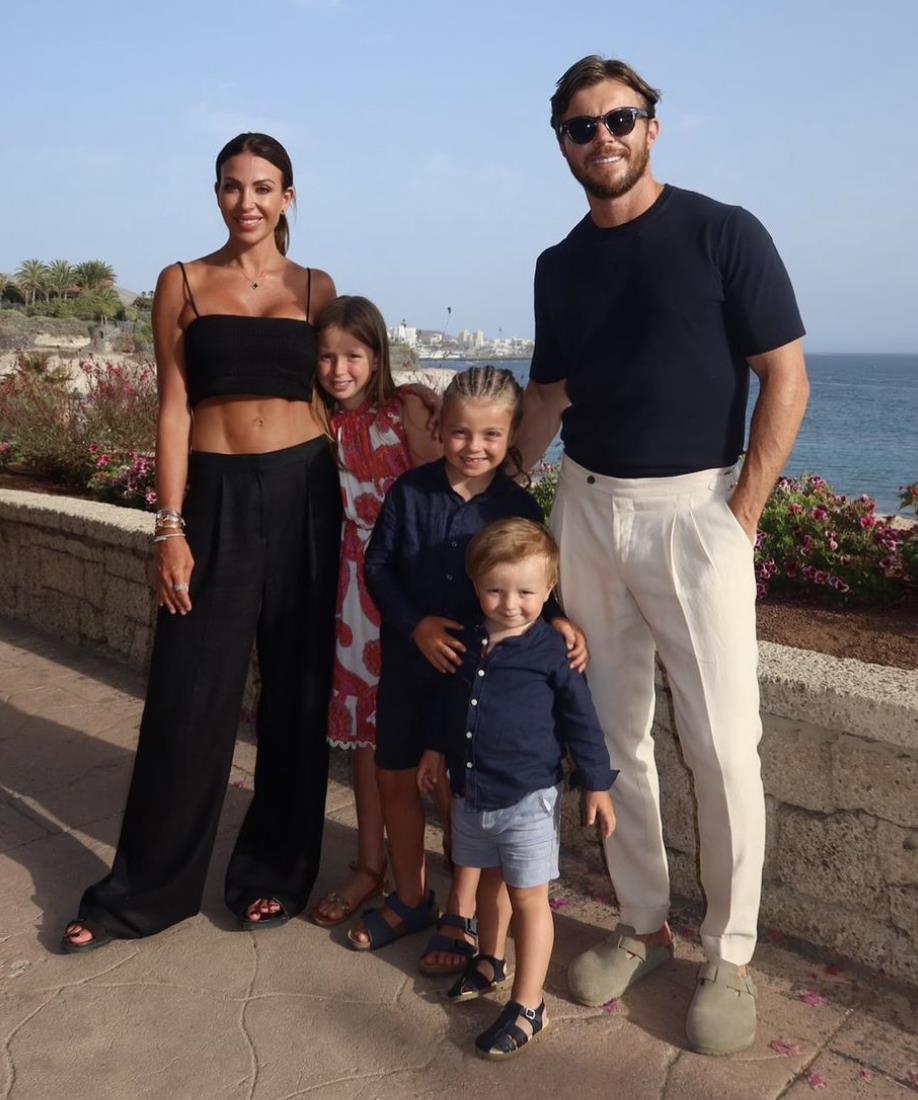 a family posing for a picture in front of the ocean