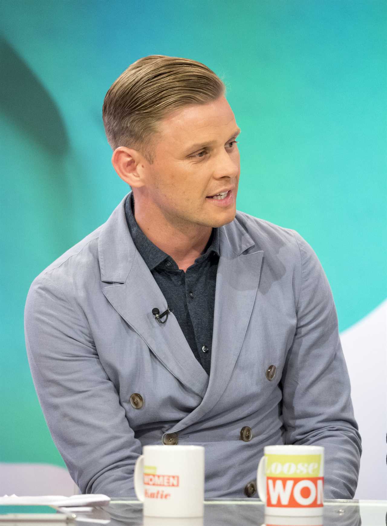 a man sits at a table next to a cup that says ' wok ' on it