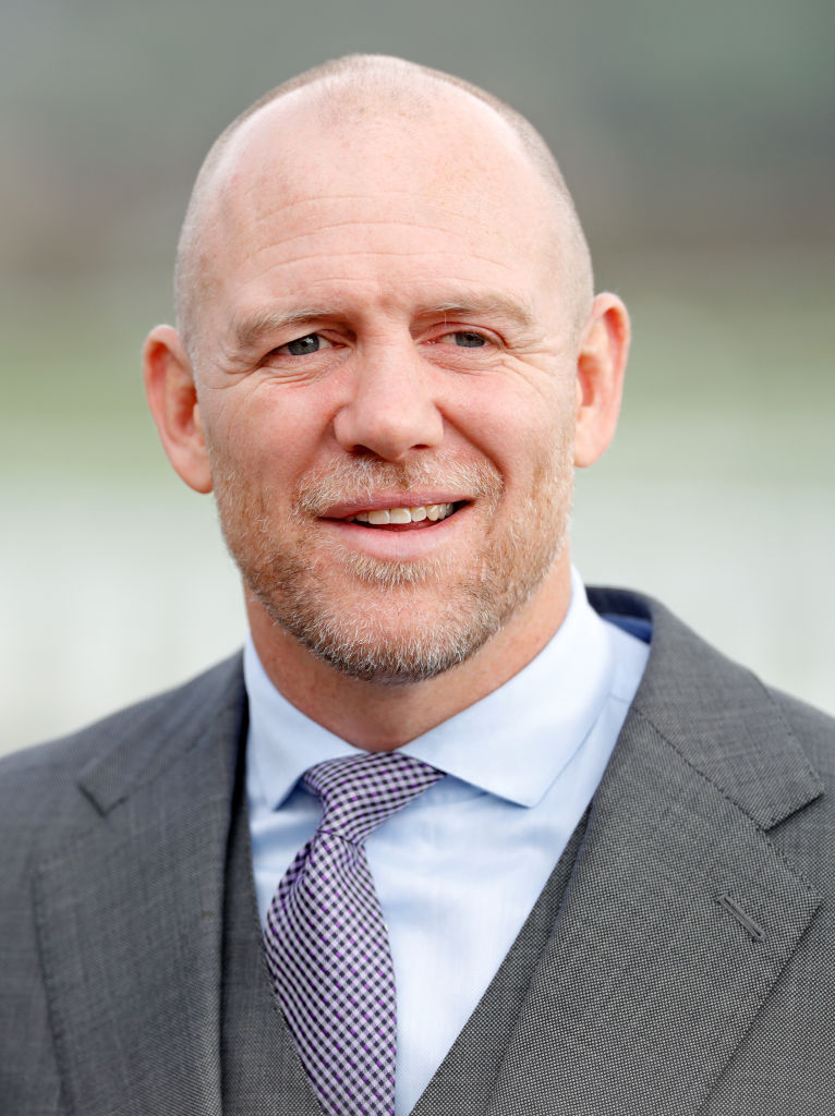 a man in a suit and tie smiles for the camera