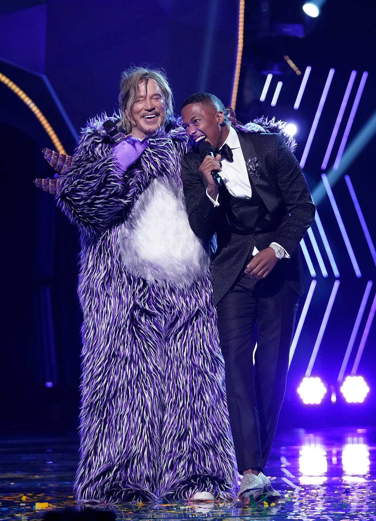 Mickey Rourke in a purple costume with Nick Cannon on The Masked Singer.