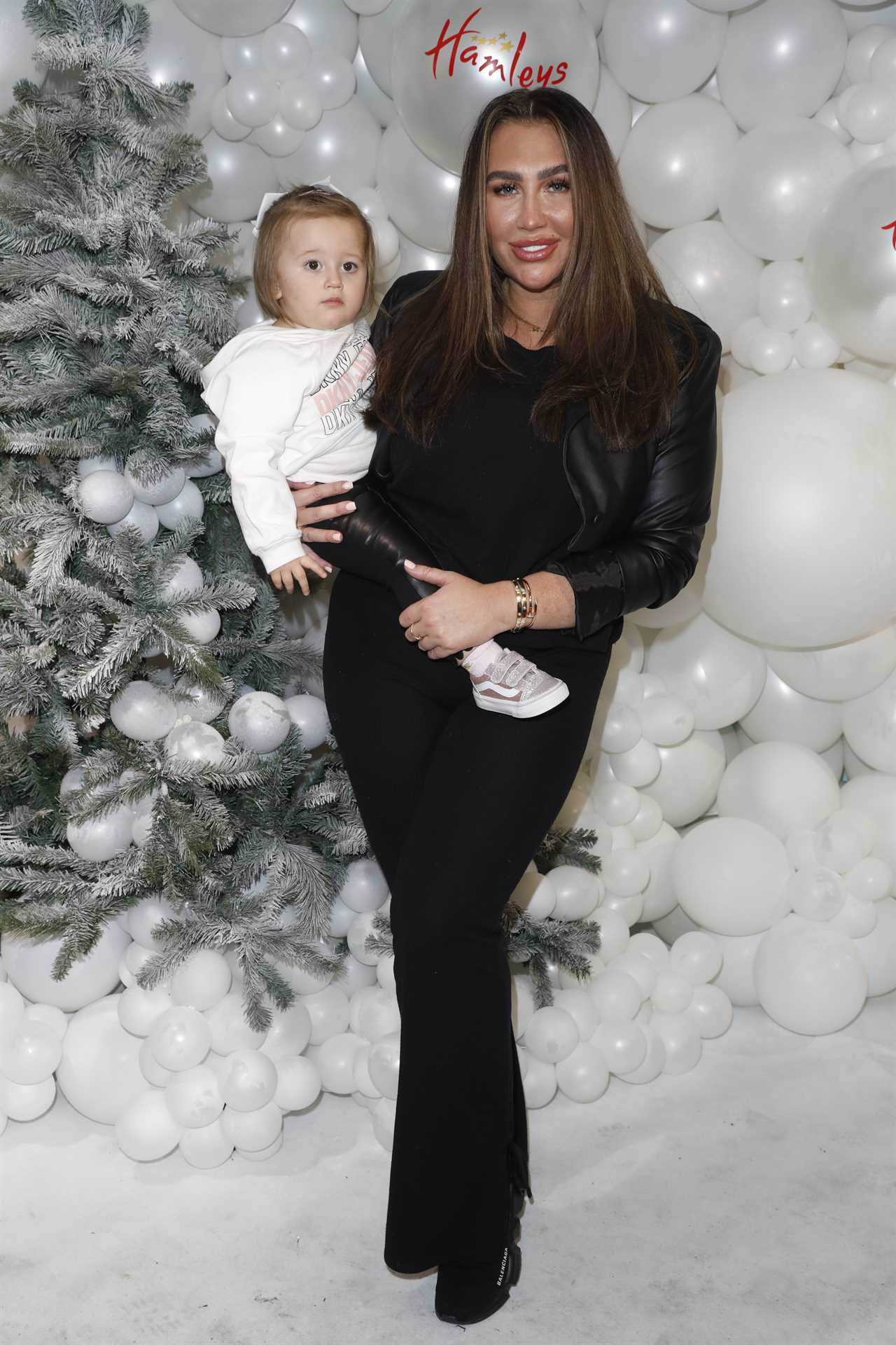 Lauren Goodger at a Christmas event, holding her young daughter.